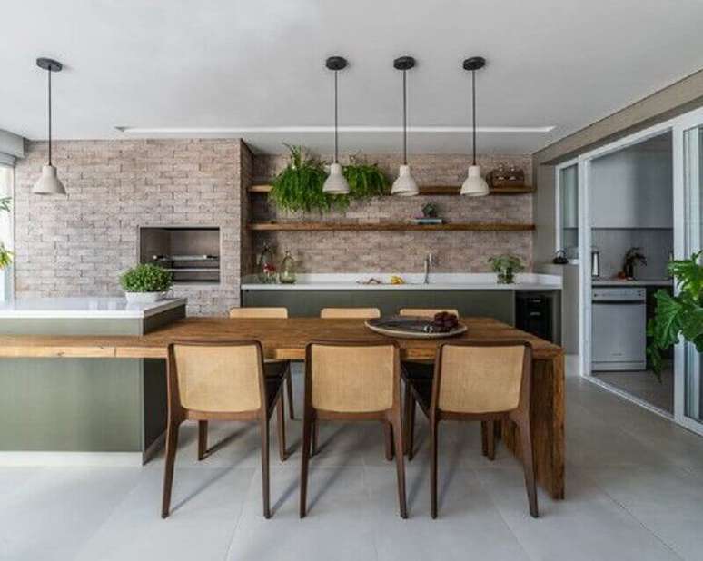 42. Modelos de área gourmet grande e moderna decorada com ilha planejada com mesa – Foto: Archdaily