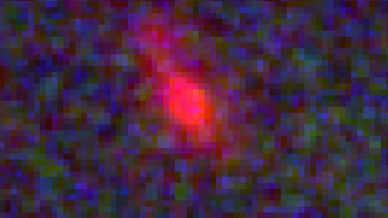 Esta é uma das galáxias que os pesquisadores estudaram, vista apenas 500 milhões de anos após o Big Bang — é tão distante que, mesmo observada pelos telescópios mais poderosos do mundo, aparece pixelada