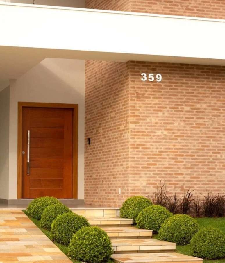 56. O revestimento para &aacute;rea externa em tijolinho aparente traz um toque r&uacute;stico para o projeto. Projeto de Vendramini Arquitetura