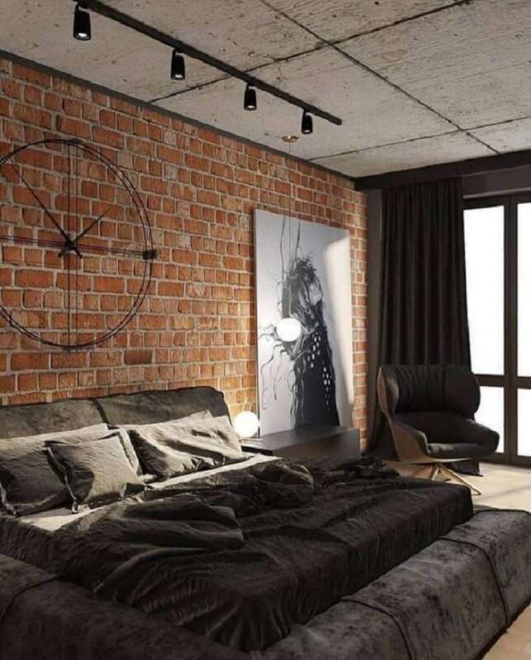 47. Quarto estilo industrial decorado com trilho de luz e parede de tijolinho – Foto: Futurist Architecture