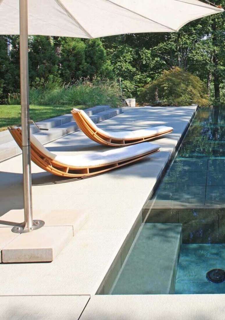 39. Decoração para área externa com piscina e espreguiçadeira de madeira com design arrojado – Foto: Pinterest