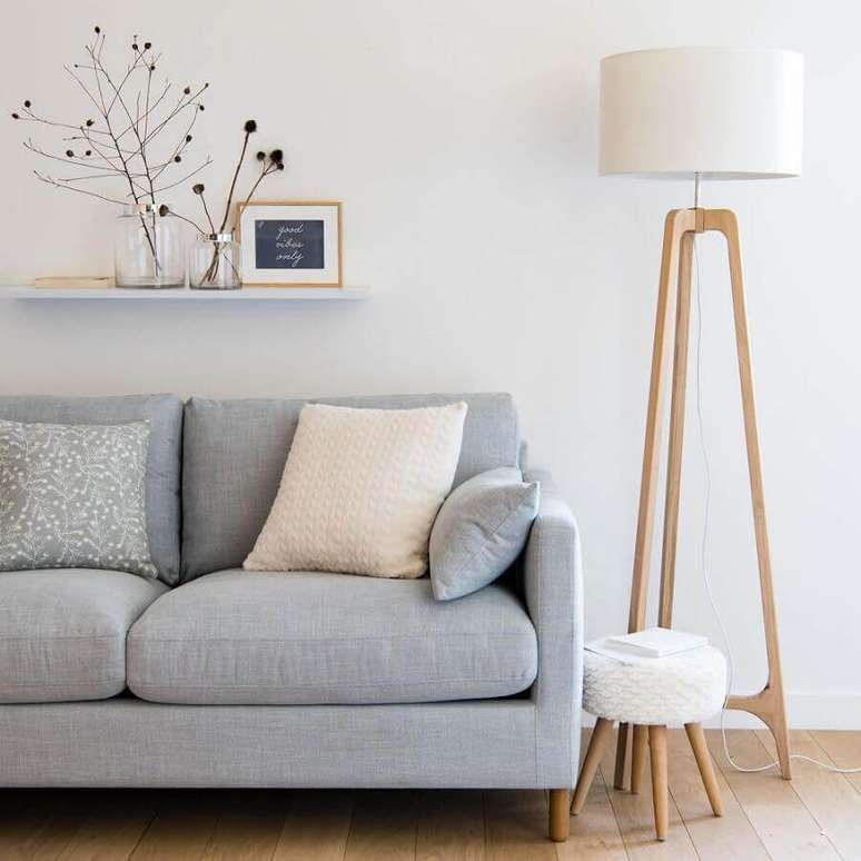 1. Abajur de pé de madeira para sala minimalista decorada com sofá cinza claro – Foto: Maisons du Monde