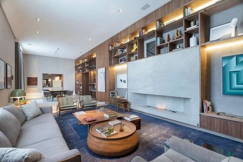 10. Decoração moderna para sala grande com lareira a gás e estante de madeira planejada – Foto: Anexo Arquitetura