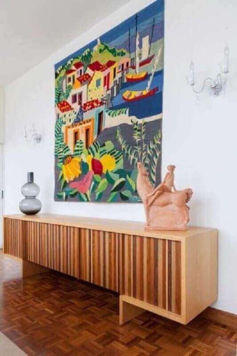 52. Sala de jantar decorada com quadro grande colorido e buffet de madeira moderno &ndash; Foto: Jeito de Casa