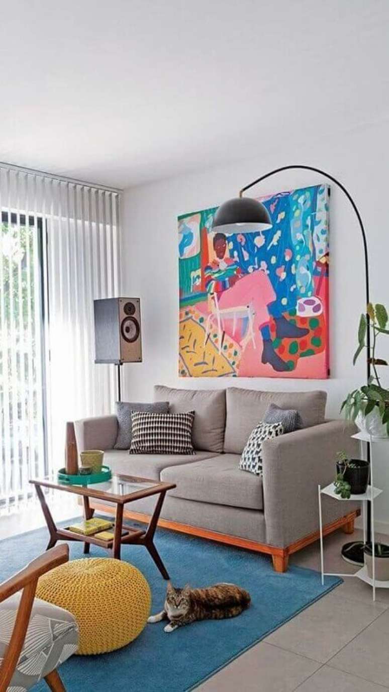 49. Objetos de decoração para sala pequena com sofá cinza e quadro grande colorido – Foto: Pinterest