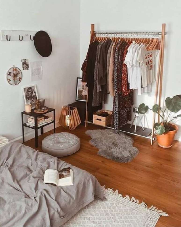 58. Os cabides de madeira real&ccedil;am ainda mais a beleza da arara de madeira no quarto. Fonte: Pinterest