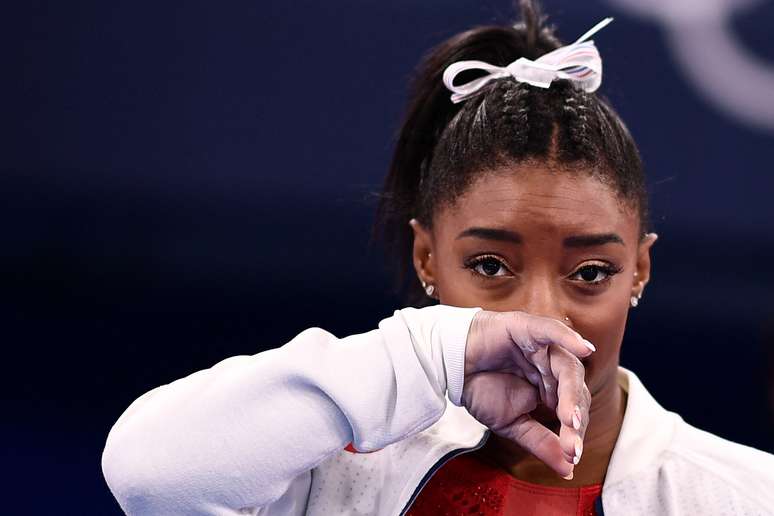 (FILES) In this file photo taken on July 27, 2021 USA's Simone Biles gestures during the artistic gymnastics women's team final during the Tokyo 2020 Olympic Games at the Ariake Gymnastics Centre in Tokyo. - Simone Biles withdrew from Olympics all-around gymnastics on July 28, 2021. (Photo by Loic VENANCE / AFP)