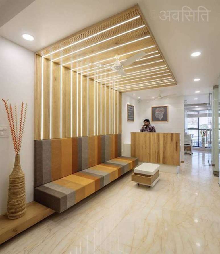 62. Sala de espera com sofá planejado listrado e moderno – Foto The Architects
