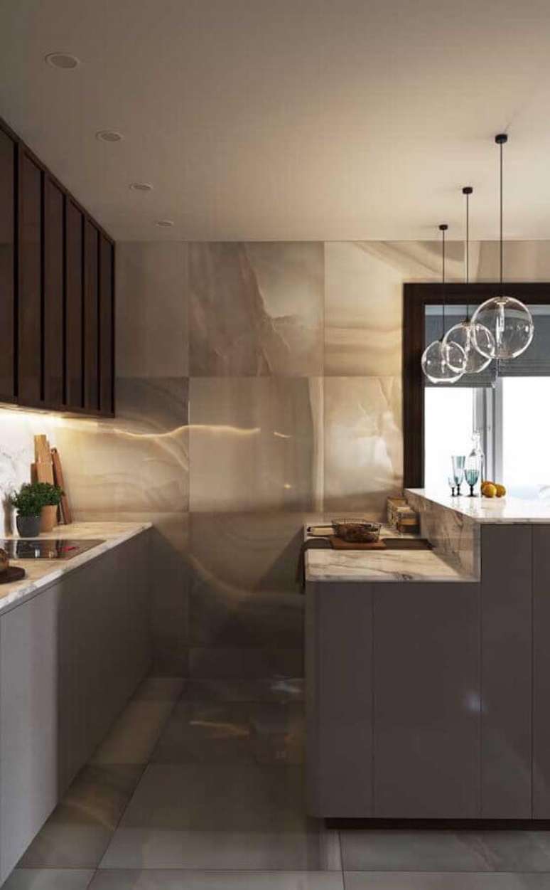 49. Decoração moderna em tons de cinza para cozinha estilo americana planejada com luminária de vidro – Foto: Apartment Therapy