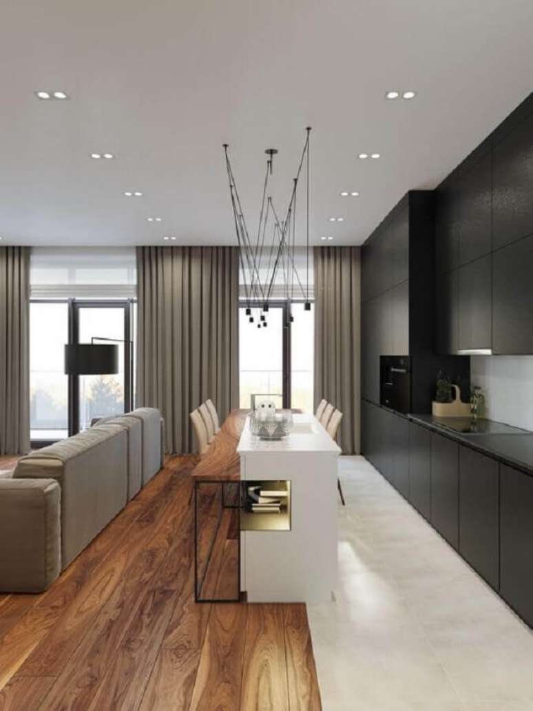 9. Estilo de cozinha americana com ilha decorada com arm&aacute;rio preto planejado &ndash; Foto: Futurist Architecture