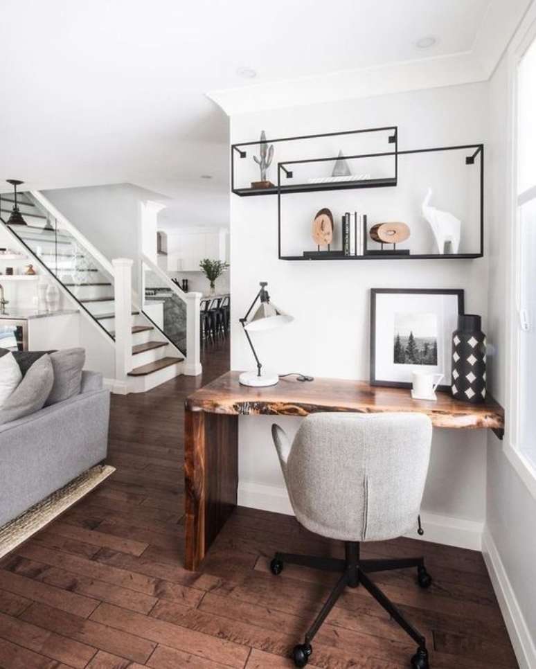 36. Home office na sala de estar com mesa de madeira rustica e cadeira giratoria cinza &ndash; Foto Poploly
