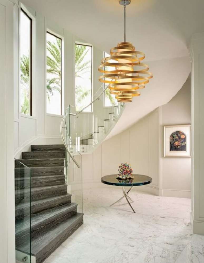 24. Lustre pendente para escada com design dourado. Fonte: Pinterest