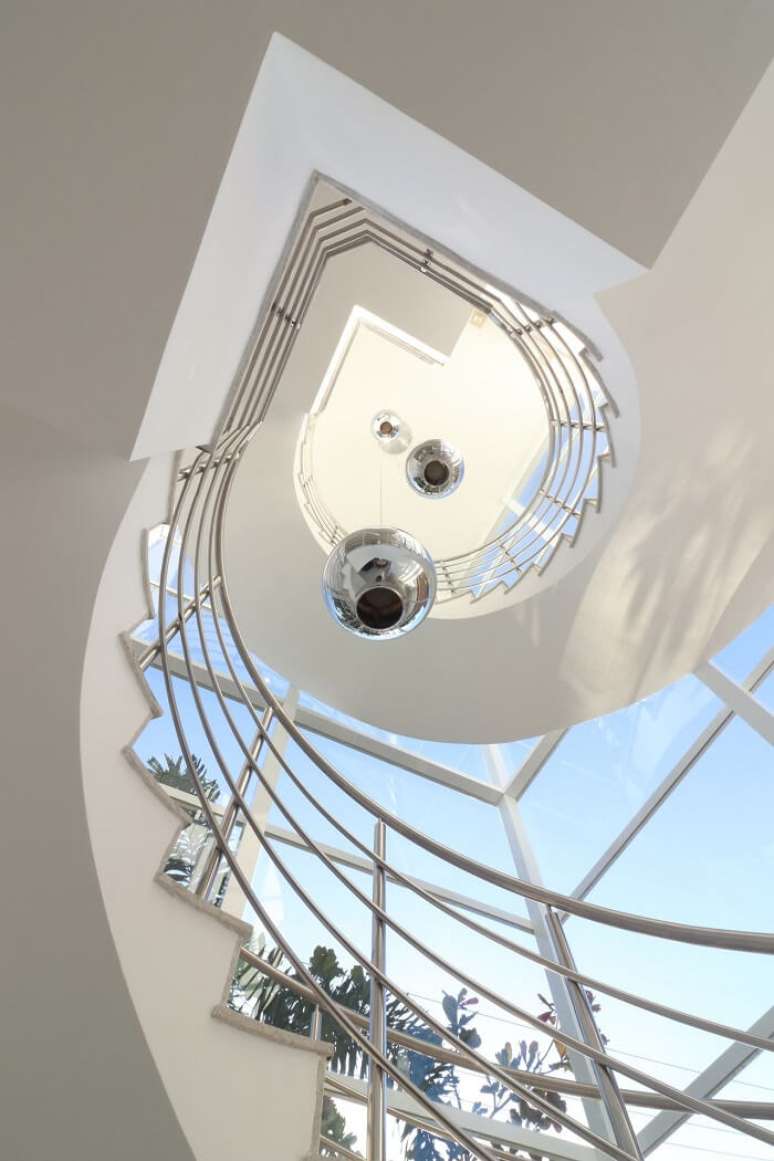 25. Modelo de lustre para escada pé direito alto metálico. Projeto de RAWI Arquitetura + Design