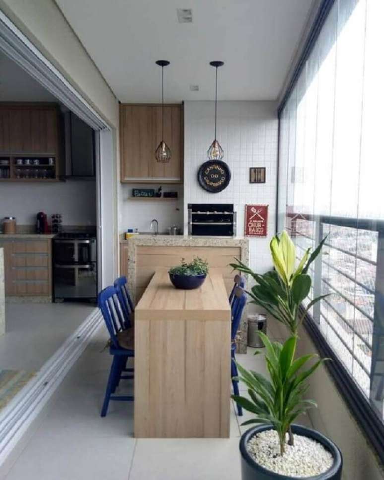 63. Varanda gourmet para apartamento pequeno decorada com cadeiras azuis – Foto: Dicas de Mulher