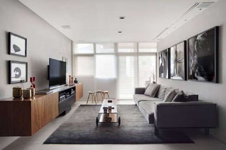 30. Decora&ccedil;&atilde;o sala cinza e branco com rack de madeira e quadros grandes &ndash; Foto: Jeito de Casa