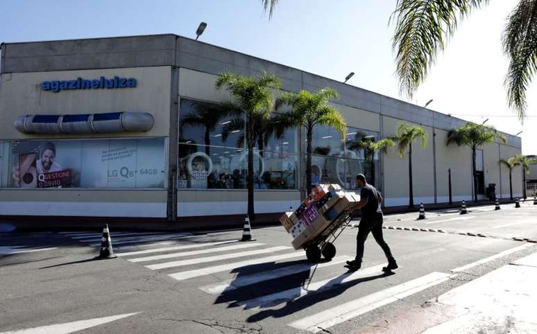 Homem transporta produtos na frente de lojas do Magazine Luiza. 21/4/2018.  REUTERS/Paulo Whitaker 