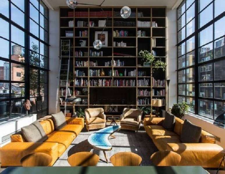 60. Aproveite a toda a extens&atilde;o da parede do im&oacute;vel com p&eacute; direito duplo para montar um biblioteca particular. Fonte: Revista Viva Decora