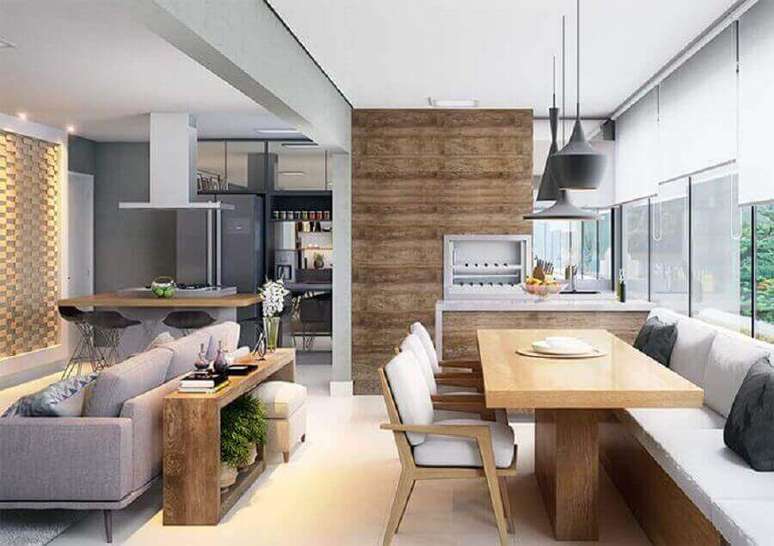 10. Decoração com lustre para área gourmet integrada com sala de estar e cozinha – Foto: Pinterest