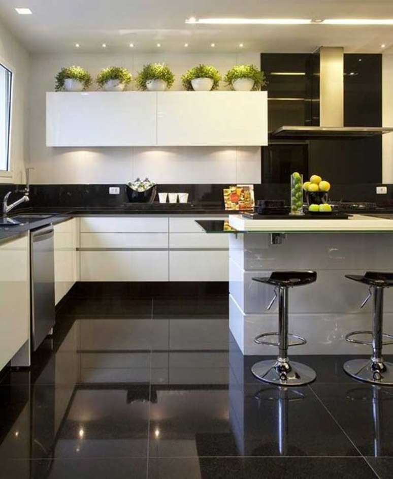 10. Porcelanato para cozinha preta e branca com ilha gourmet e banquetas modernas – Foto Sua Decoração