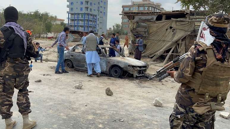 Afegãos tiram foto de veículo de onde foguetes foram disparados enquanto soldado do Talibã faz a guarda em Cabul
30/08/2021 REUTER/Stringer 