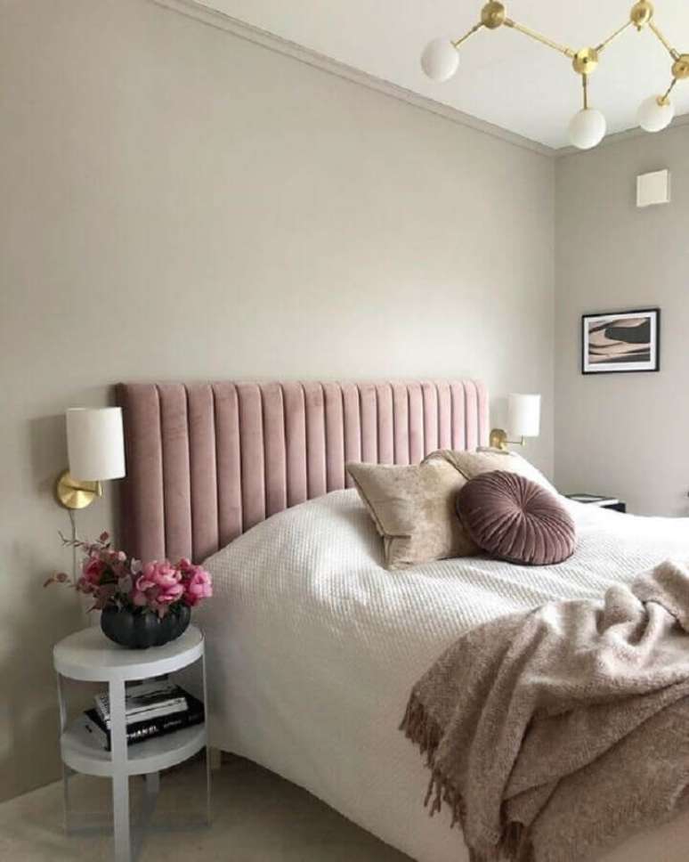 40. Decoração de quarto feminino com cabeceira de cama box rosa e arandela de parede – Foto: Curated Interior