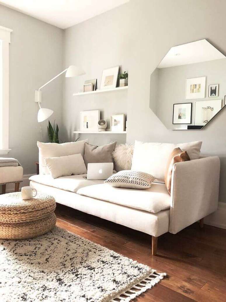 38. Espelho na sala de estar decorada em cores claras com sofá moderno – Foto: Apartment Therapy