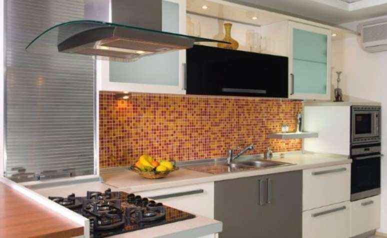 37. Cozinha com arm&aacute;rio de vidro e pastilhas laranja &ndash; Foto iStock