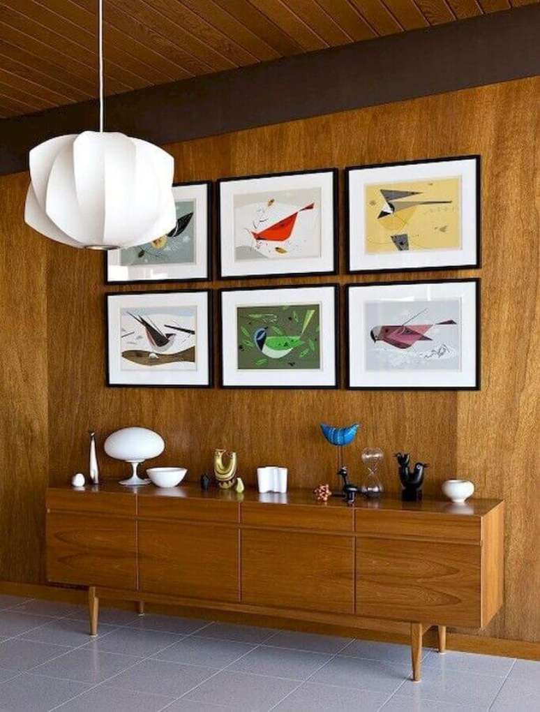 51. Quadros para decoração de sala de jantar com buffet de madeira e lustre moderno – Foto: Essential Home