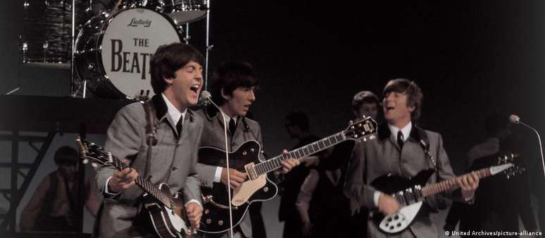 Paul, George e John durante um show em 1962