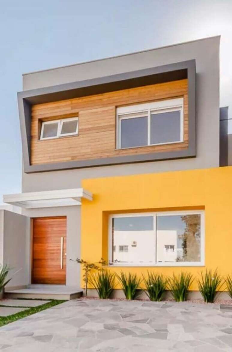 5. Ideia de cores de casas modernas externa com fachada cinza e amarela – Foto: Decor Fácil