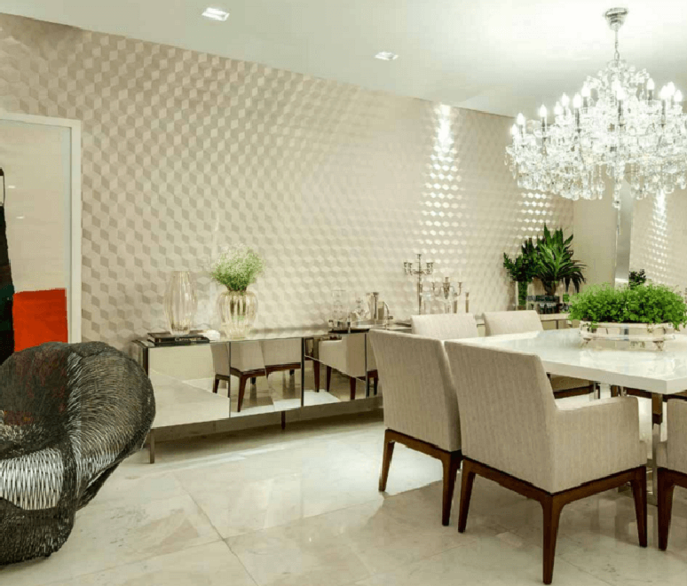 76. Sala de jantar com decoração clean e parede com placa de gesso 3D e lustre de cristal. Fonte: Decoratips