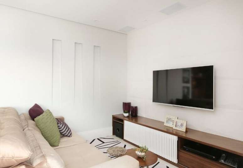 49. Sof&aacute; creme e rack para sala moderno. Fonte: Bianchi & Lima Arquitetura