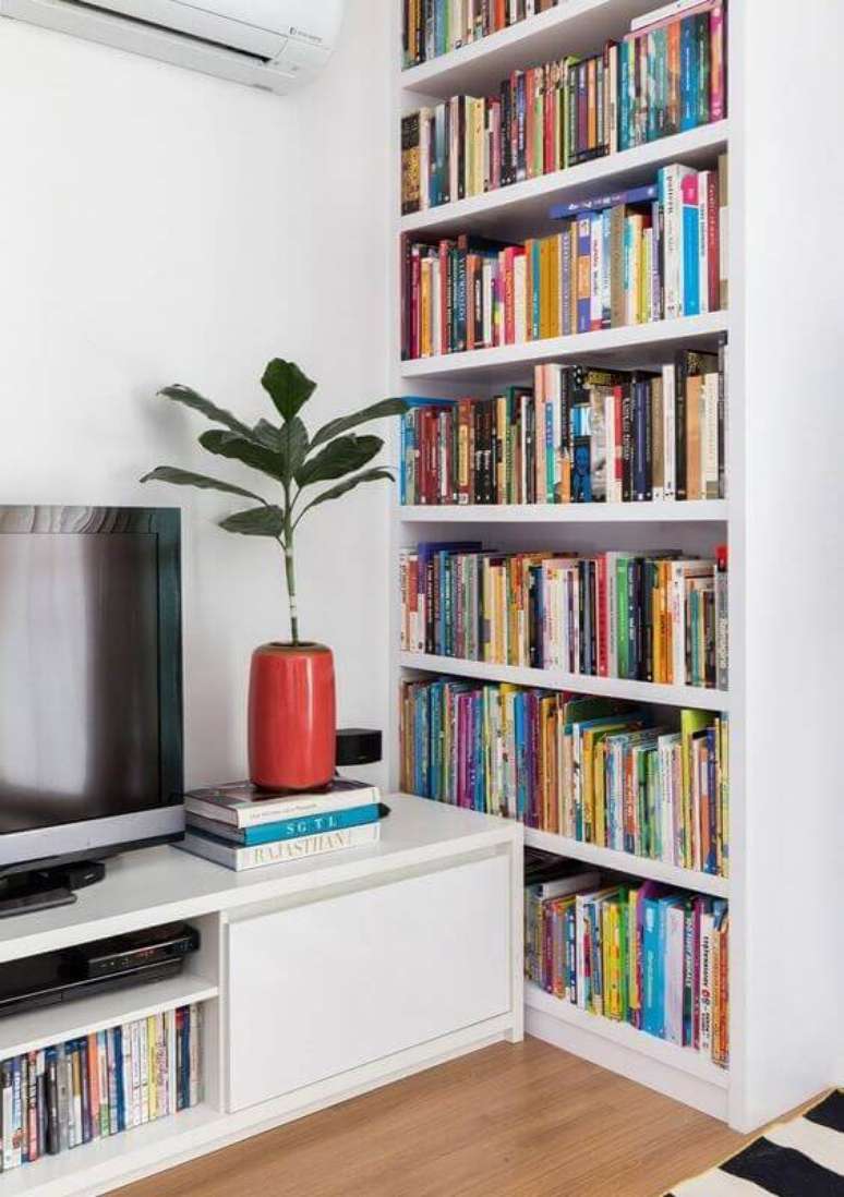 27. Decoração clean para sala de TV branca com armário para livros planejado – Foto: Rafaela Paoli