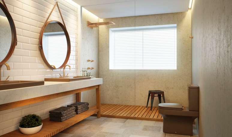 7. Banheiro com chuveiro dourado e torneiras da mesma cor -Foto DECA