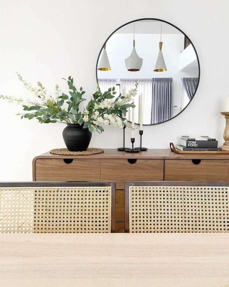 37. Decoração com espelho redondo e balcão para sala de jantar em madeira – Foto: Zura Nashrudin