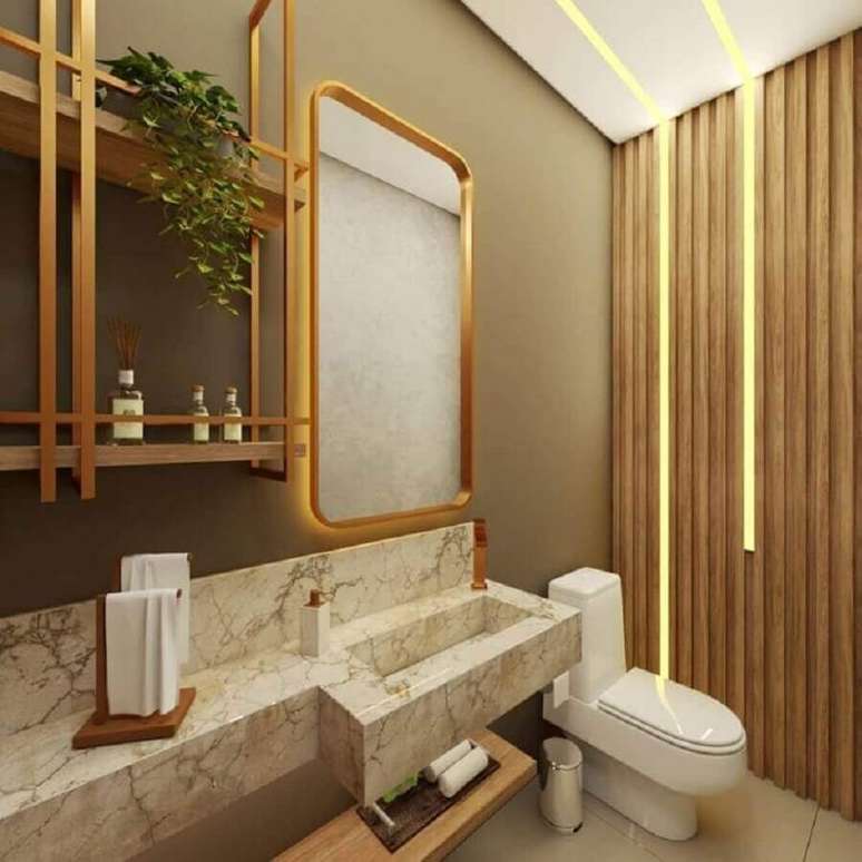 12. Cor camurça na parede de lavabo moderno decorado com bancada de mármore e revestimento de madeira – Foto: Gardesign Studio