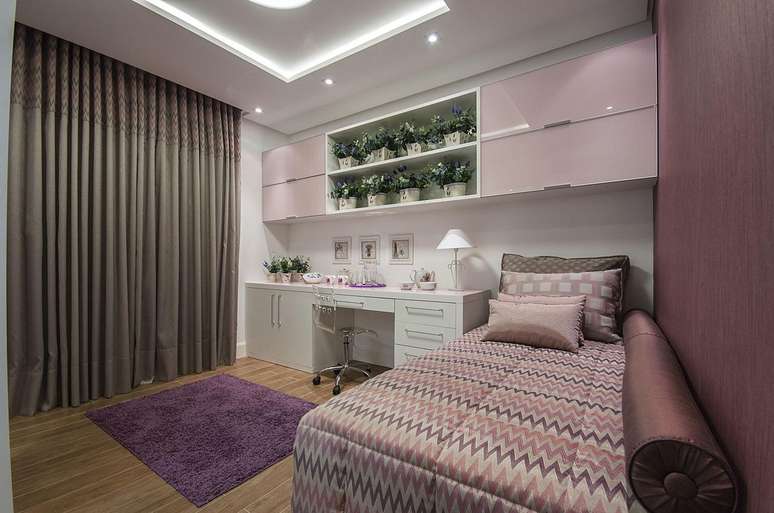 13. Decoração de quarto lilás com móveis brancos e parede pintada de roxo – Projeto Grupo Factory