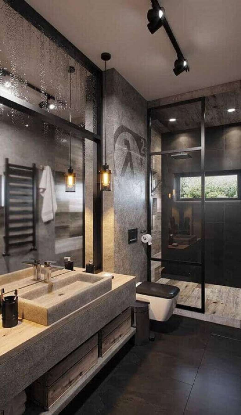 16. Banheiro industrial moderno decorado com luminária trilho e cimento queimado – Foto: Home Designing