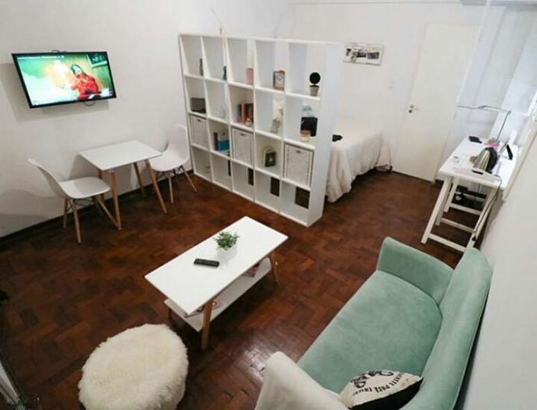 51. A estante vazada separa quarto e sala do apartamento studio decorado. Fonte: Amanda Ramalho Arquitetura