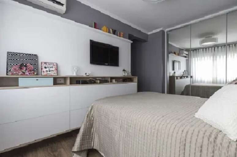 32. Guarda roupa moderno espelhado e tv no quarto. Fonte: Modi Arquitetura e Interiores