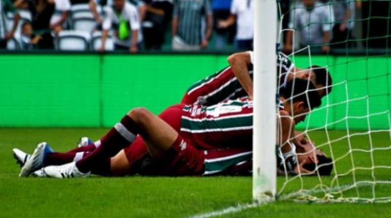 Ganso caído com a mão na boca e, ao mesmo tempo, sendo festejado pelos companheiros de Fluminense (MAILSON SANTANA/FLUMINENSE FC)