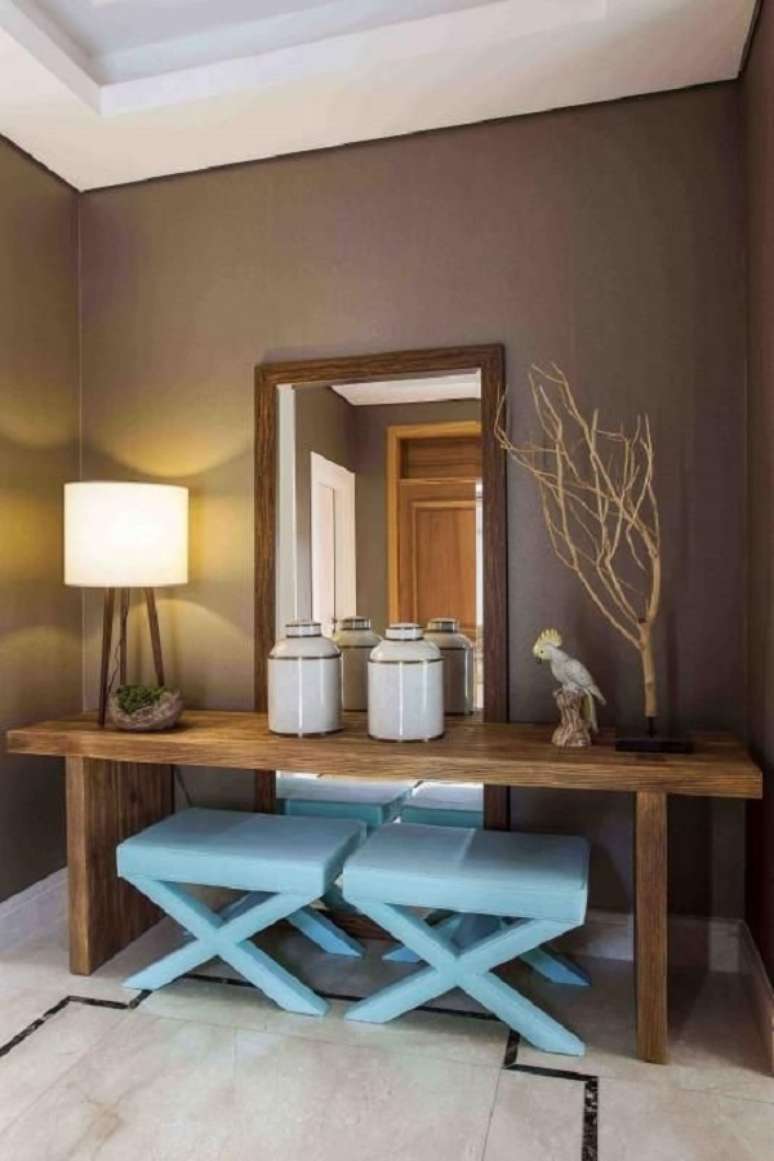 20. Hall de entrada simples com aparador de madeira e pufe azul &ndash; Foto Meyer Cortez Arquitetura e Design