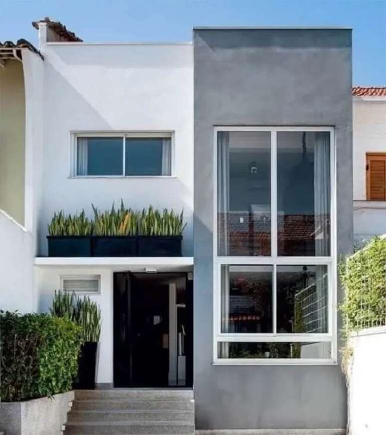 38. Grandes aberturas favorecem a iluminação natural da casa sobrado com fachada cinza e branco. Fonte: Luciana Galves Arquitetura