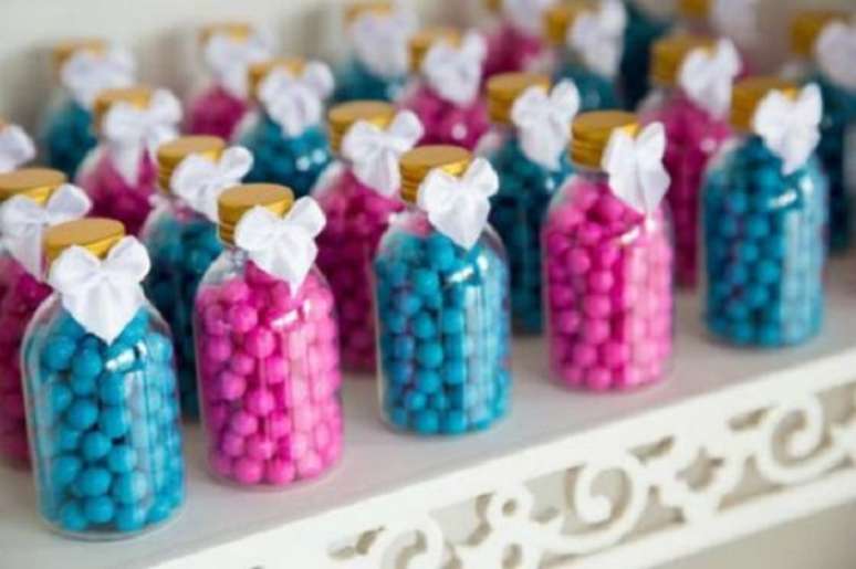 48- Na festa chá de revelação, os vidrinhos com balas azuis e rosa, são lembrancinhas que decoram a mesa. Fonte: Festas. Site