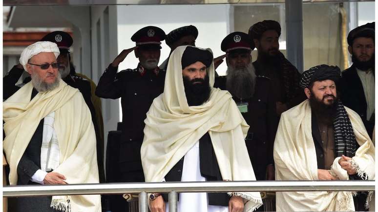 O ministro do Interior do Talebã, Sirajuddin Haqqani (ao centro), e o vice-primeiro-ministro do Talebã, Abdul Salam Hanafi (à esquerda), participam de uma cerimônia de formatura para novos recrutas da polícia afegã na Academia de Polícia em Cabul, em 5 de março de 2022