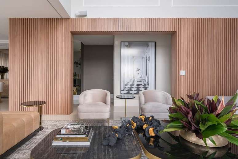 2. O painel ripado em madeira carvalho se destaca no living. Foto: Kadu Lopes