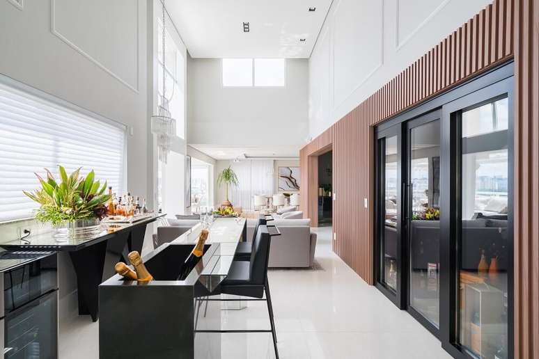 3. O painel ripado em madeira Carvalho envolve a estrutura da adega. Foto: Kadu Lopes