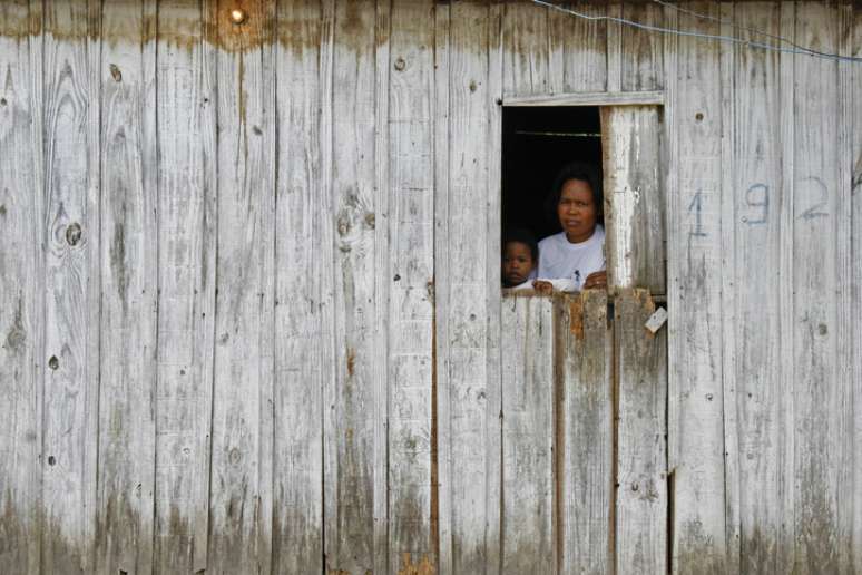 Mãe e filha em casa de madeira