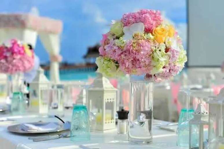 73. Na decora&ccedil;&atilde;o de casamento, as flores das mesas t&ecirc;m cores suaves e delicadas. Fonte: Guia de Casamento