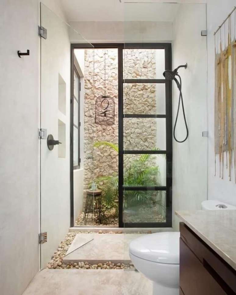 17. Pedras naturais e cimento queimado branco parede decoram o espaço. Fonte – Taller Estilo Arquitectura